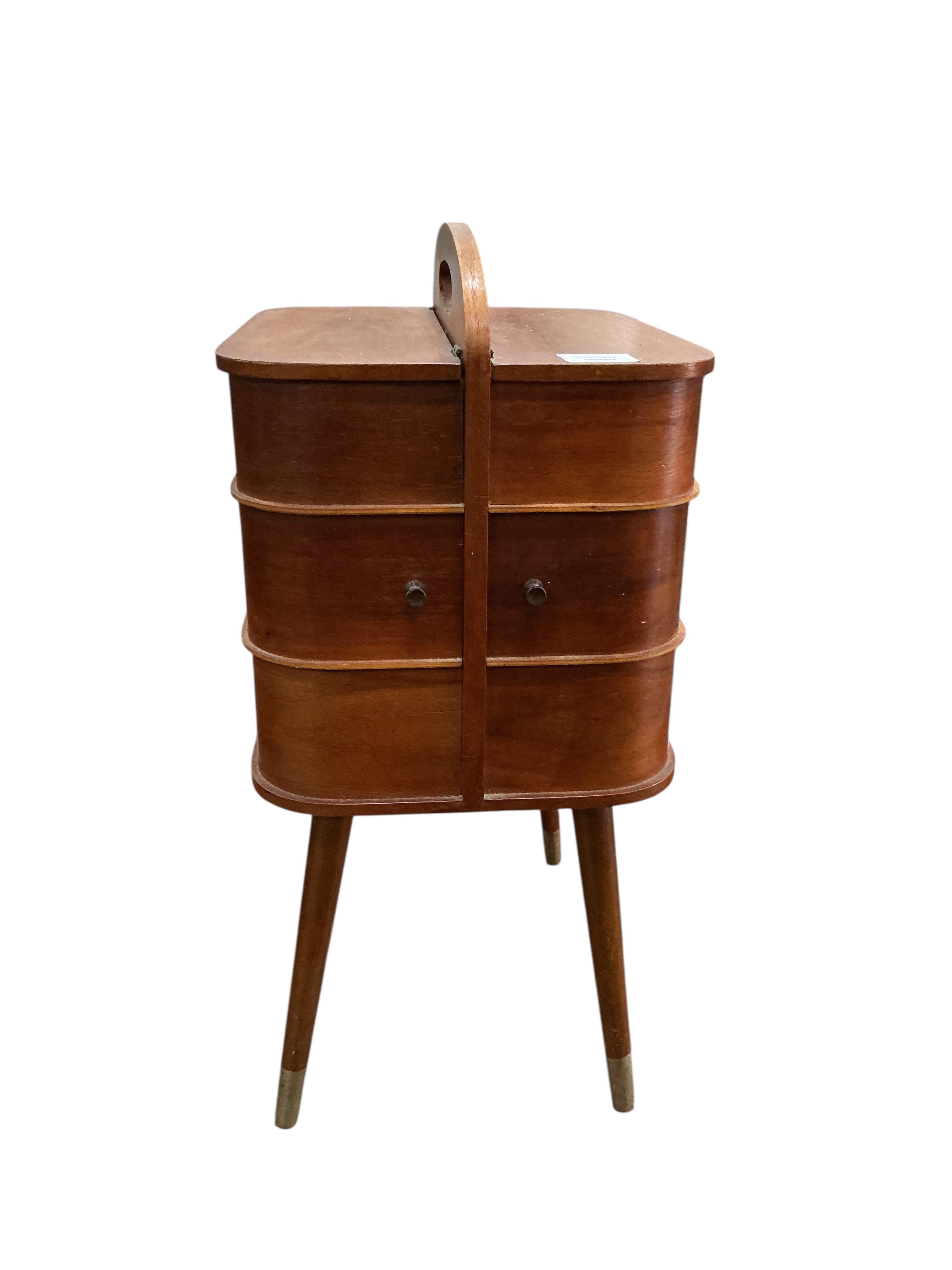 A mid century teak sewing table, width 28cm, depth 35cm, height 58cm.